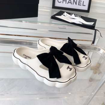 Chanel slippers in white with black bow tie 